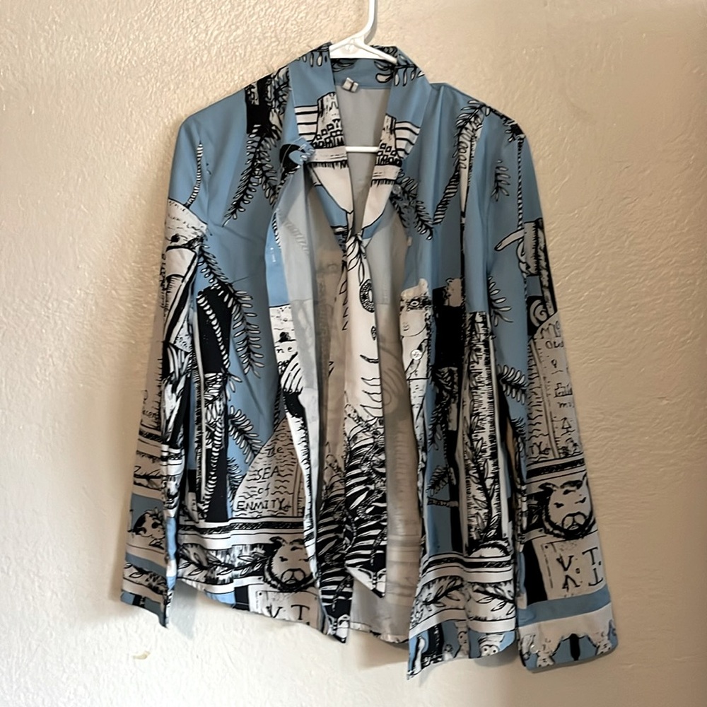 Blue button down shirt with tie and interesting drawn design